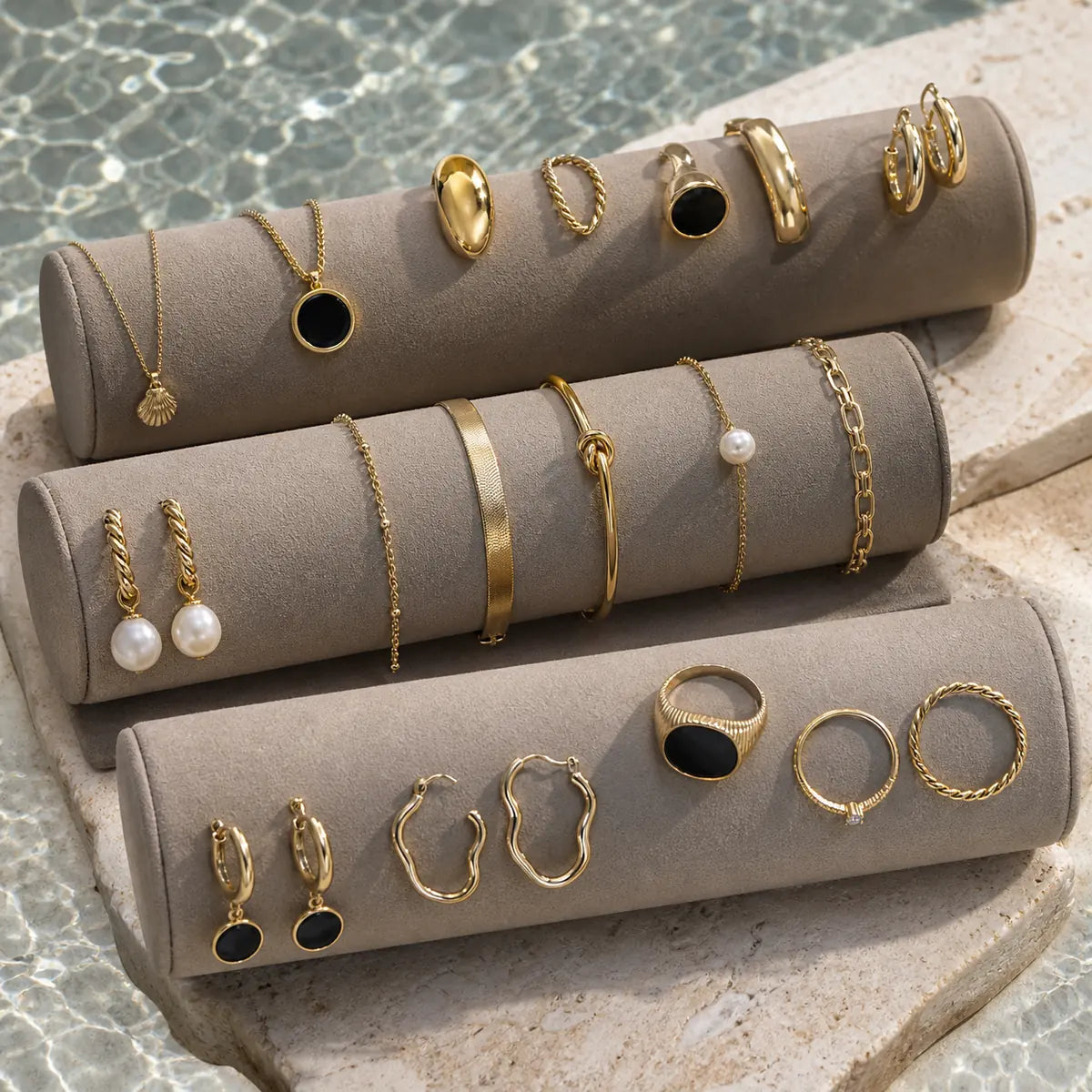 Arley Berlin gold jewellery arranged on soft display stands