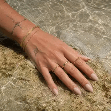 Gold Arley Berlin jewellery worn in clear seawater