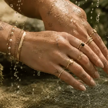 Gold Arley Berlin jewellery beneath fresh running water